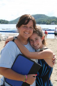 20080701020t A counselor and camper hugging on the waterfront