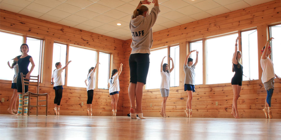 Campers and a staff member practice their ballet dancing