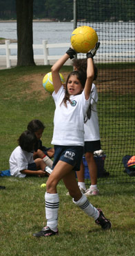 The soccer goalie prepares to throw the ball into play