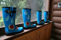 Blue rubber boots sitting on a window sill