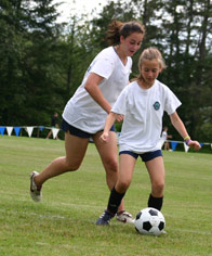 A counselor puts a little gentle pressure on a camper