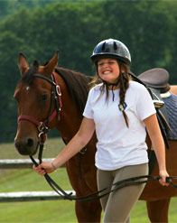 A camper leading a horse