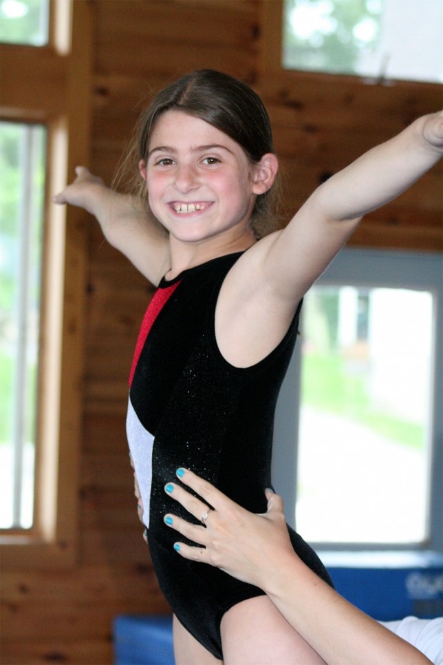 201006289206 An aspiring gymnast reaches new heights thanks to a helping hand