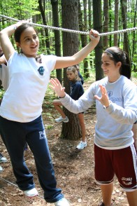 201006299491 A counselor helps a camper walk a tightrope
