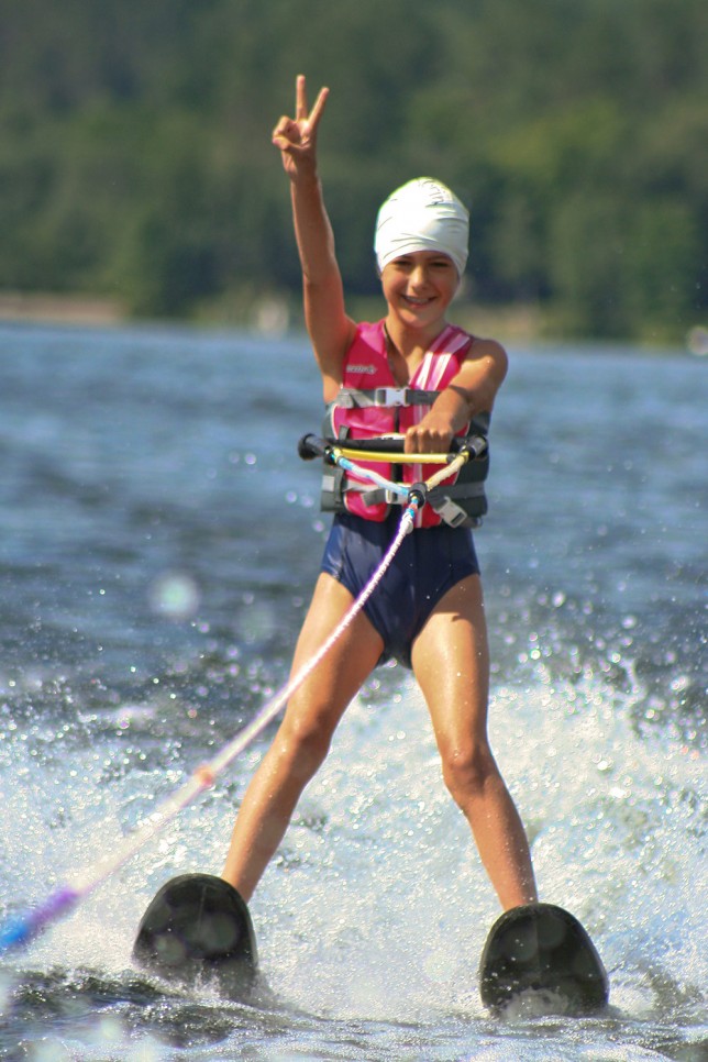 201006309973 A new skiier flashes the victory sign as she gains her feet