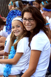 201007181454 A camper sitting on her summer counselor's lap