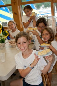 Campers showing off the braided bread they've made in cooking