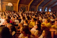 Parents, campers, and counselors sit enthralled in the audience