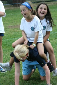 Campers riding on their summer camp counselor