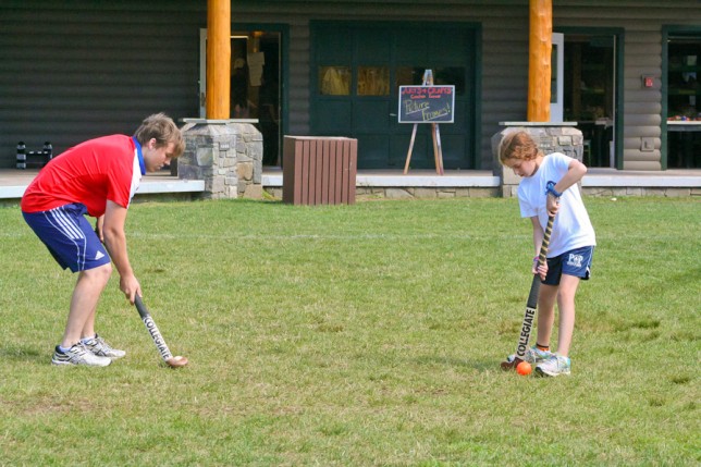 201007303822 Instructor giving tips on Field Hockey Form