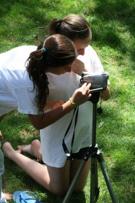 Two campers getting the right shot with a camcorder