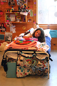 A little girl laying on her bed writing a letter home