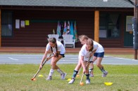 Girls learning Field Hockey