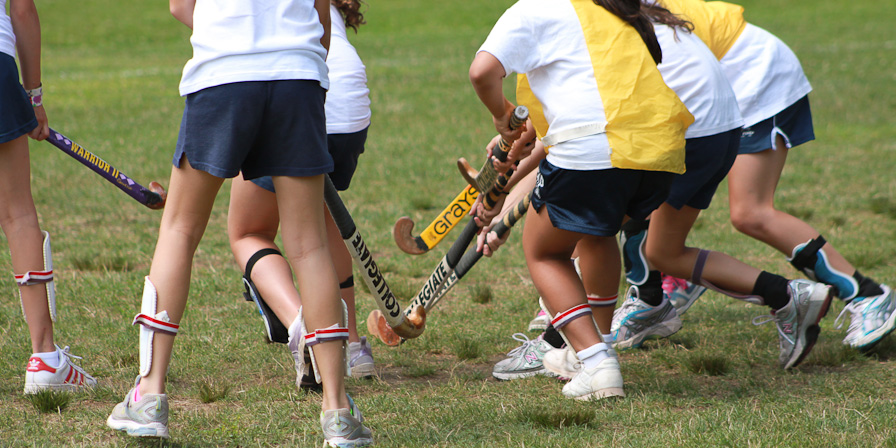Campers playing Field Hockey