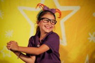 201107304425 Camper smiling on stage in front of a star.