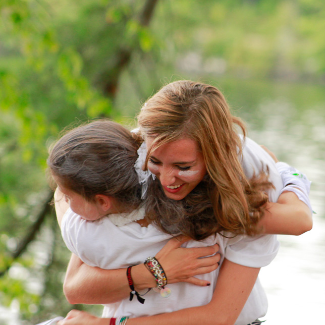 Counselor awards camper for achievement