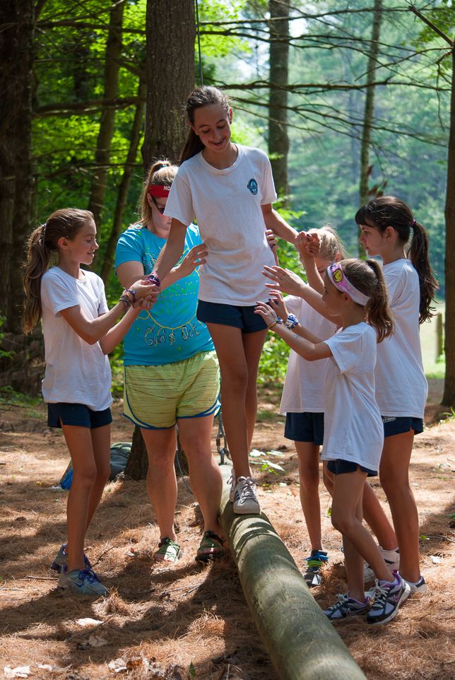 Campers helping each other at the farm.