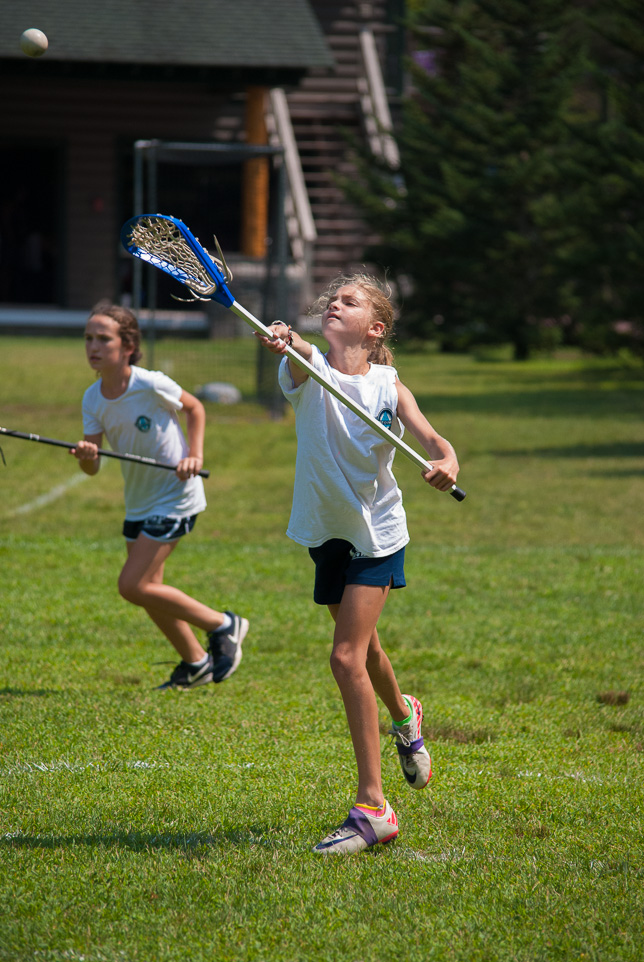 Camper passing lacrosse ball