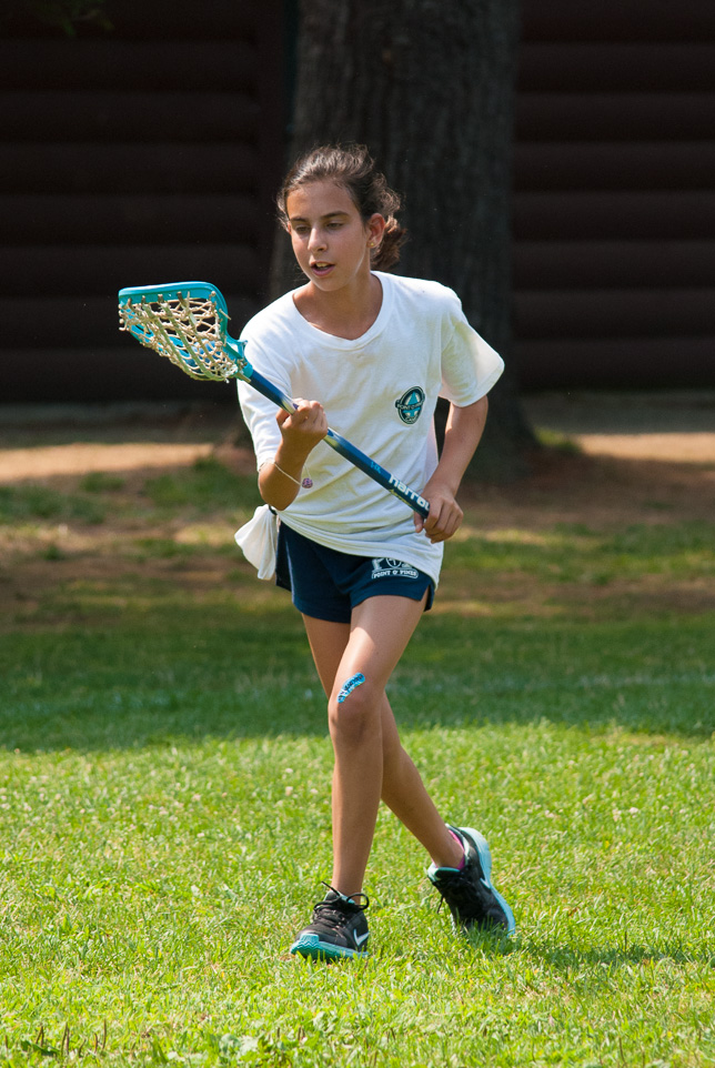 Camper carrying lacrosse ball