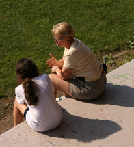 Director Sue Himoff sits with a camper at their upstate NY summer camp