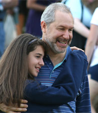A camper hugs her dad on Visiting Day