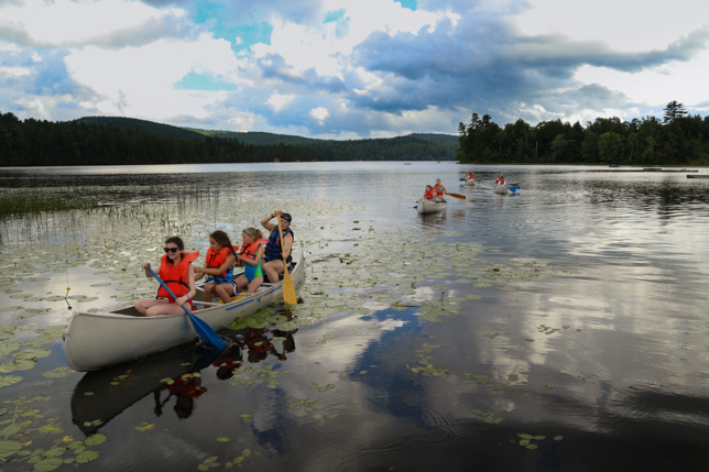 Campers canoeing to the Point O'Pines farm.